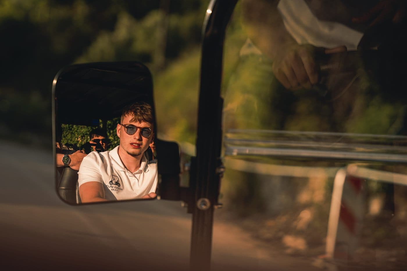 Guest reflected in the side mirror during a Hidden Split Tours ride